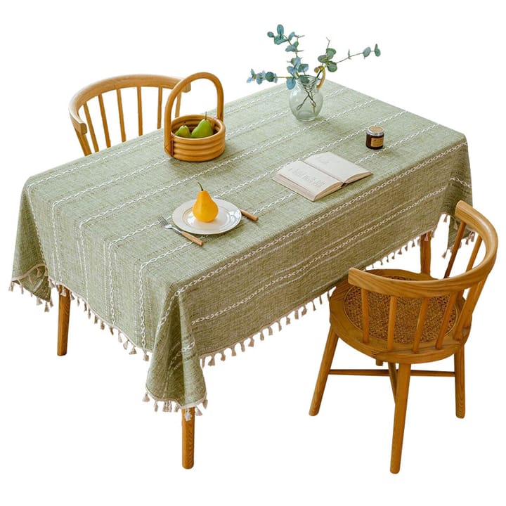 Sage woven tablecloth on a table with chairs