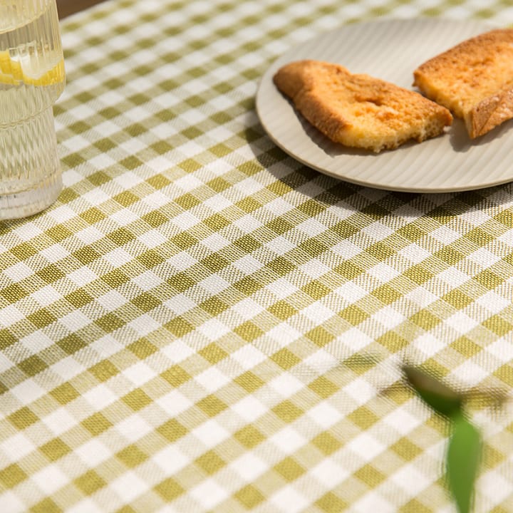 Green gingham fabric under a plate of toast