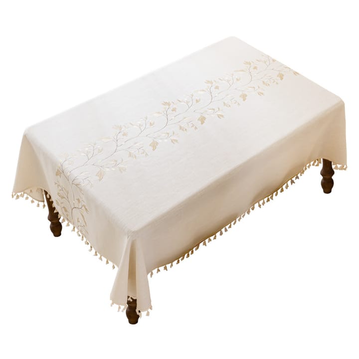 The Embroidered Leaf Tablecloth on a rectangular table