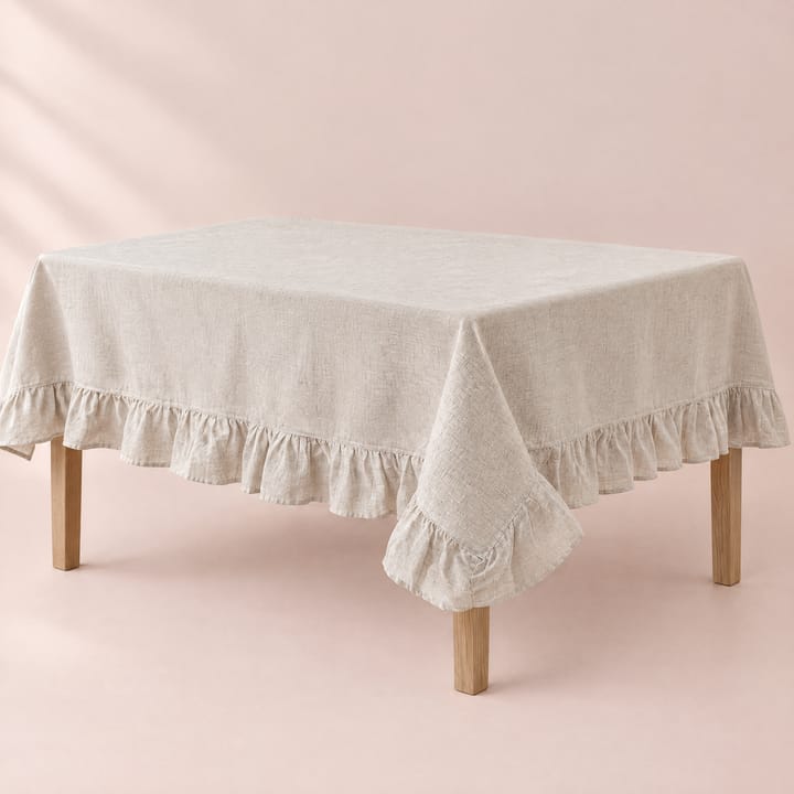 Oatmeal tablecloth with a ruffled edge on a dining table
