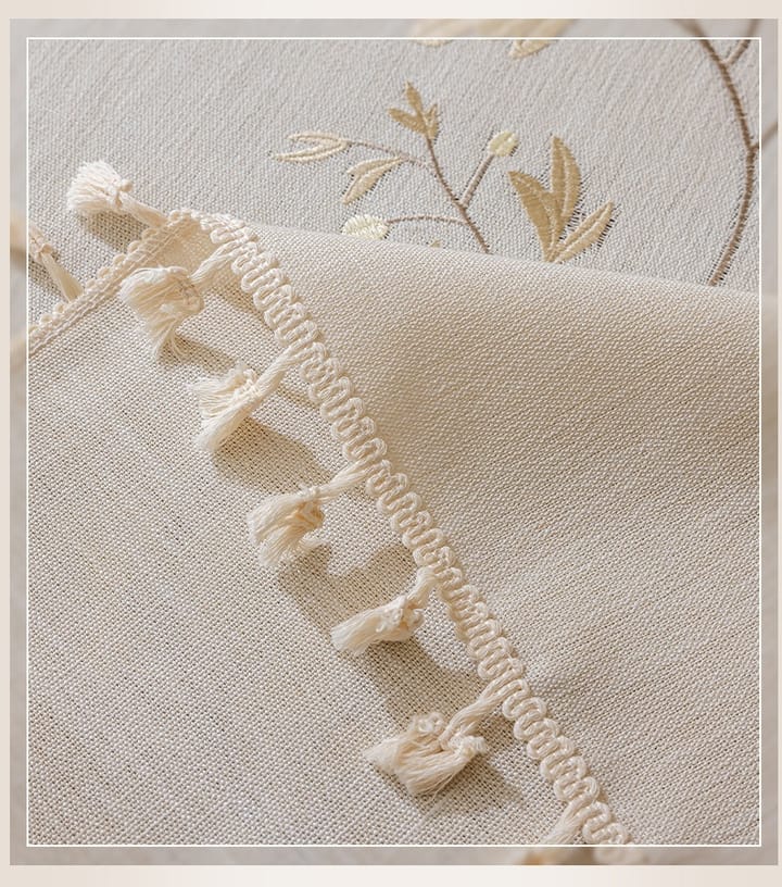 Cream tassel trim at the corner of the cloth